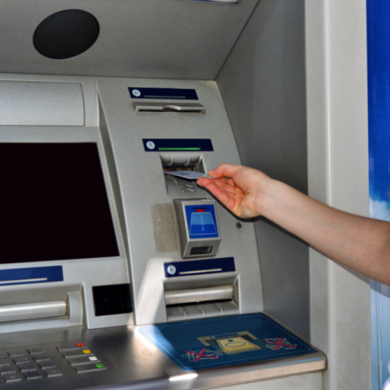 A person inserting their bank card into an ATM, protected by Superior Protection Services, a company providing security services for the financial sector.