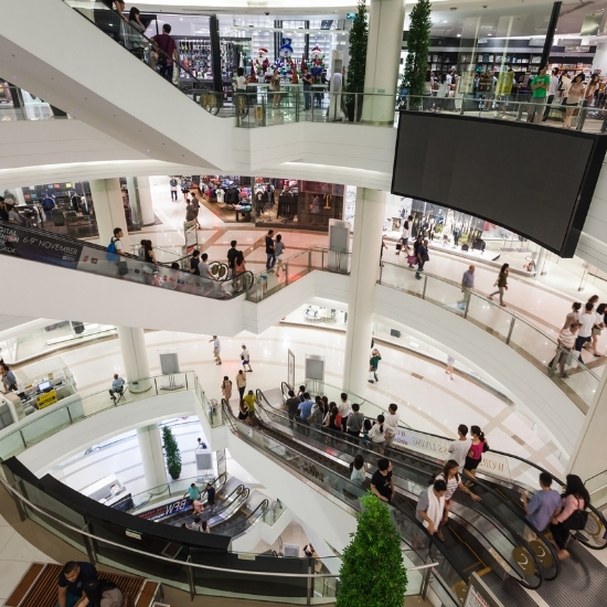 A busy mall with shoppers walking around, protected by Superior Protection Services security personnel providing security services for retail businesses.